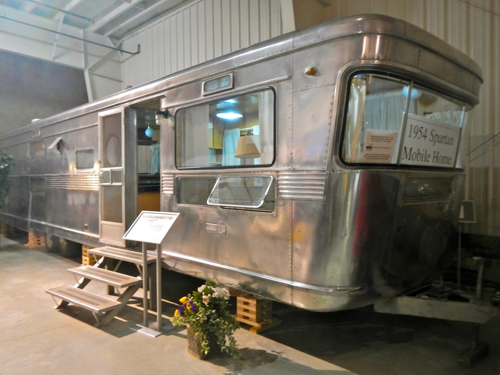 A polished 1954 Spartan aluminium mobile home on display